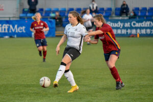 Chloe Chivers of Swansea City Ladies holds off the challenge from Lucy Finch of Cardiff Met Women