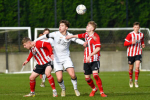 Iwan Morgan of Swansea City Under 18s battles for possession with two Sheffield United players