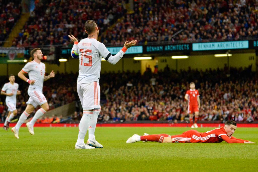 Spain's Sergio Ramos (left) protests his innocence after a foul on Harry Wilson of Wales (right)